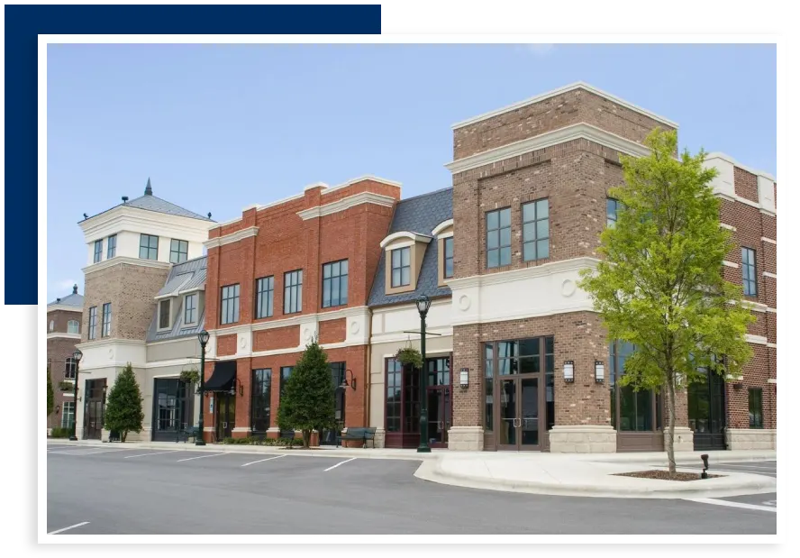 A row of brick buildings on the corner of a street.