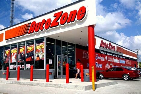 A car dealership with a red and white sign.