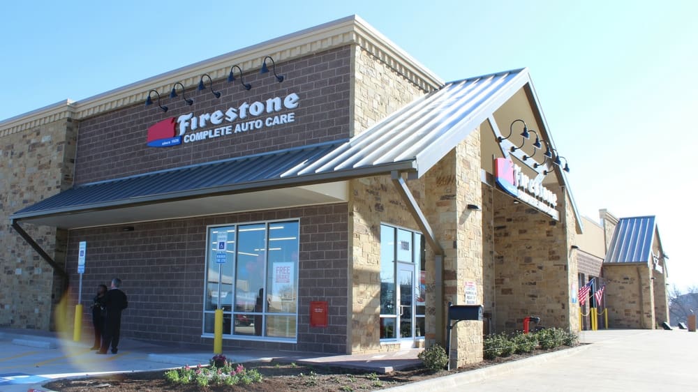 A firestone store front with the company logo on it.