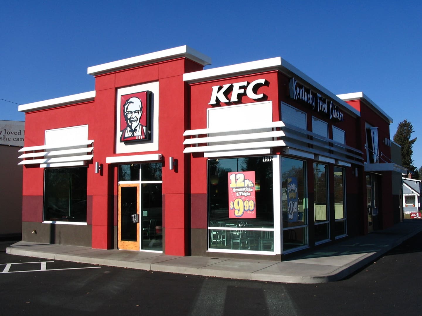 A kfc restaurant with the entrance to the building.