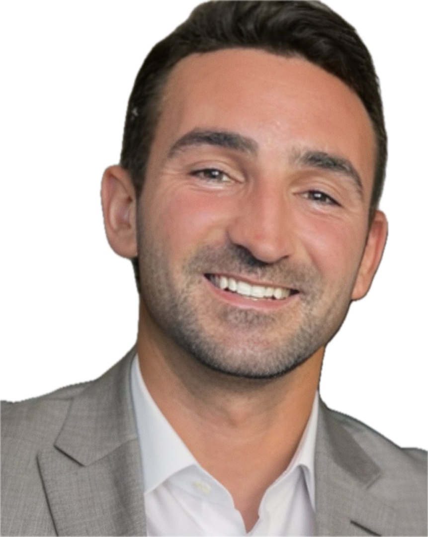 A man in a suit and tie smiling for the camera.